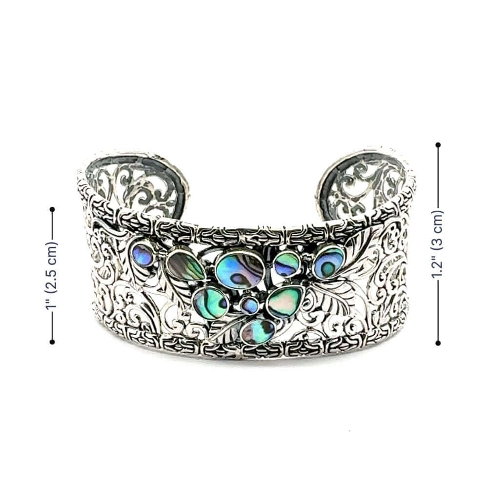 Silver cuff bracelet with colorful abalone and measurements on a white background