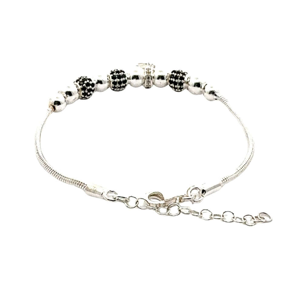 Silver bracelet with black and silver beads on a white background