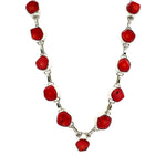 Necklace with coral and silver links on a white background