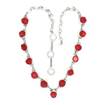 Necklace with red coral and silver chain on a white background