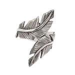 Silver feather-shaped ring on a white background