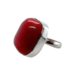 Red coral ring with silver band on a white background