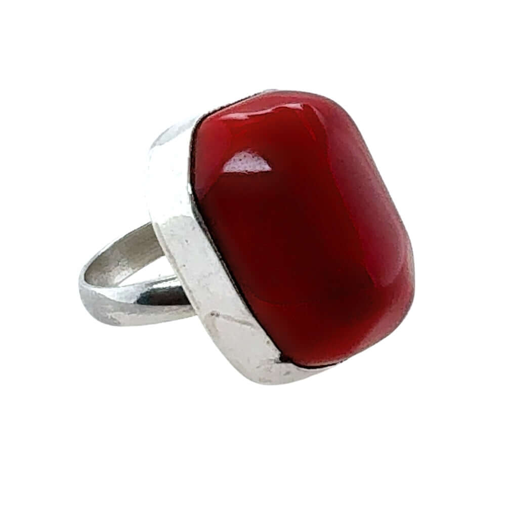 Ring with a red coral and silver band on a white background