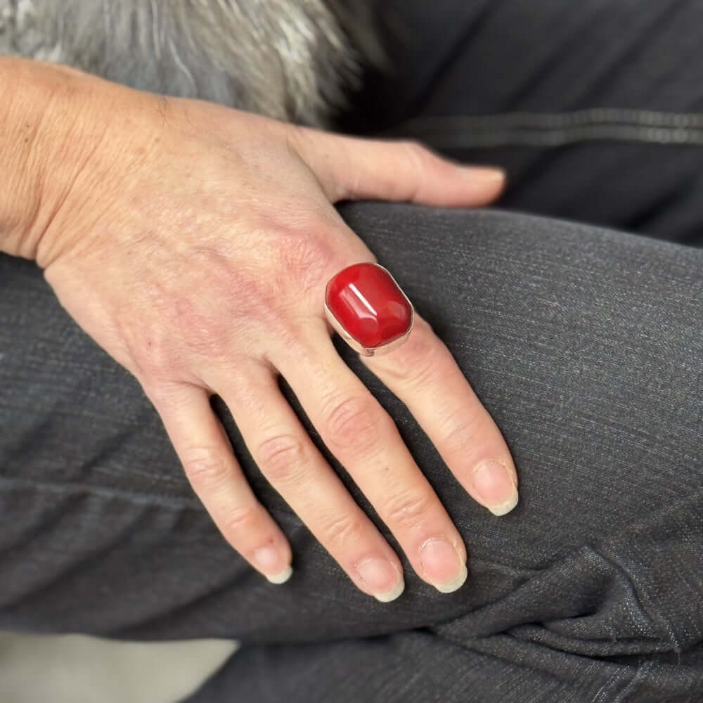 Hand with a red coral silver ring