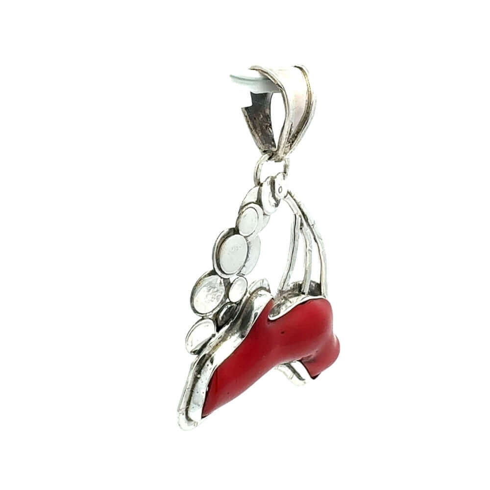 Silver pendant with red coral on a white background