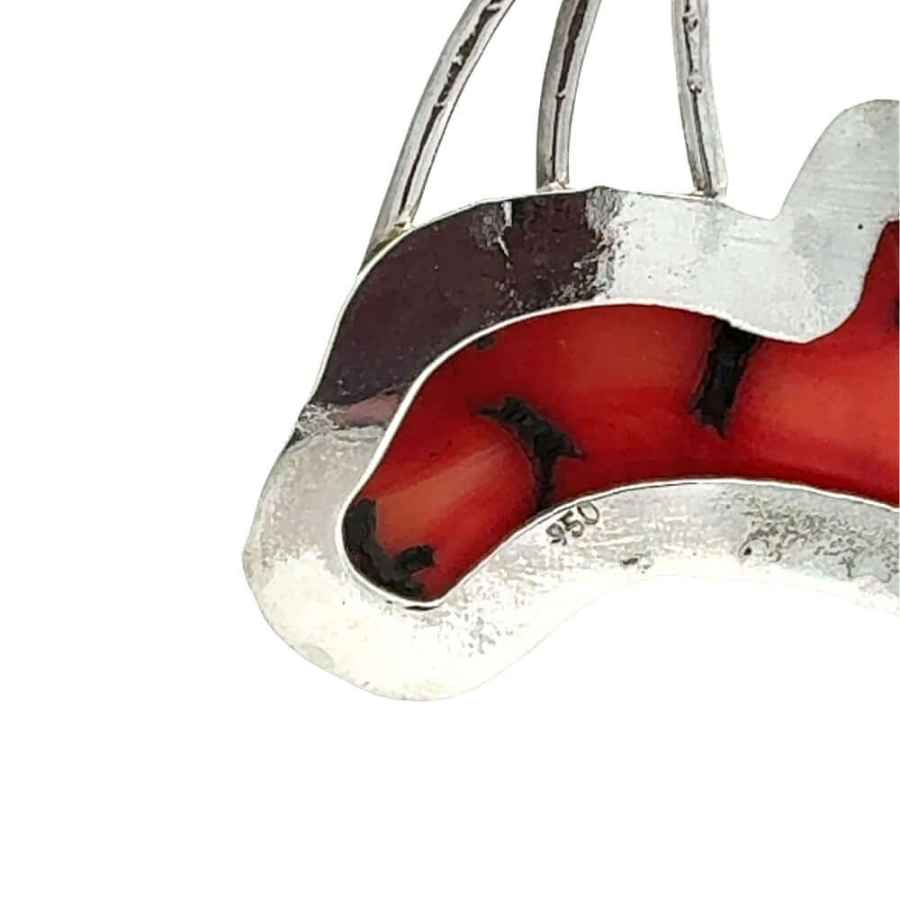 Silver and red coral pendant on a white background