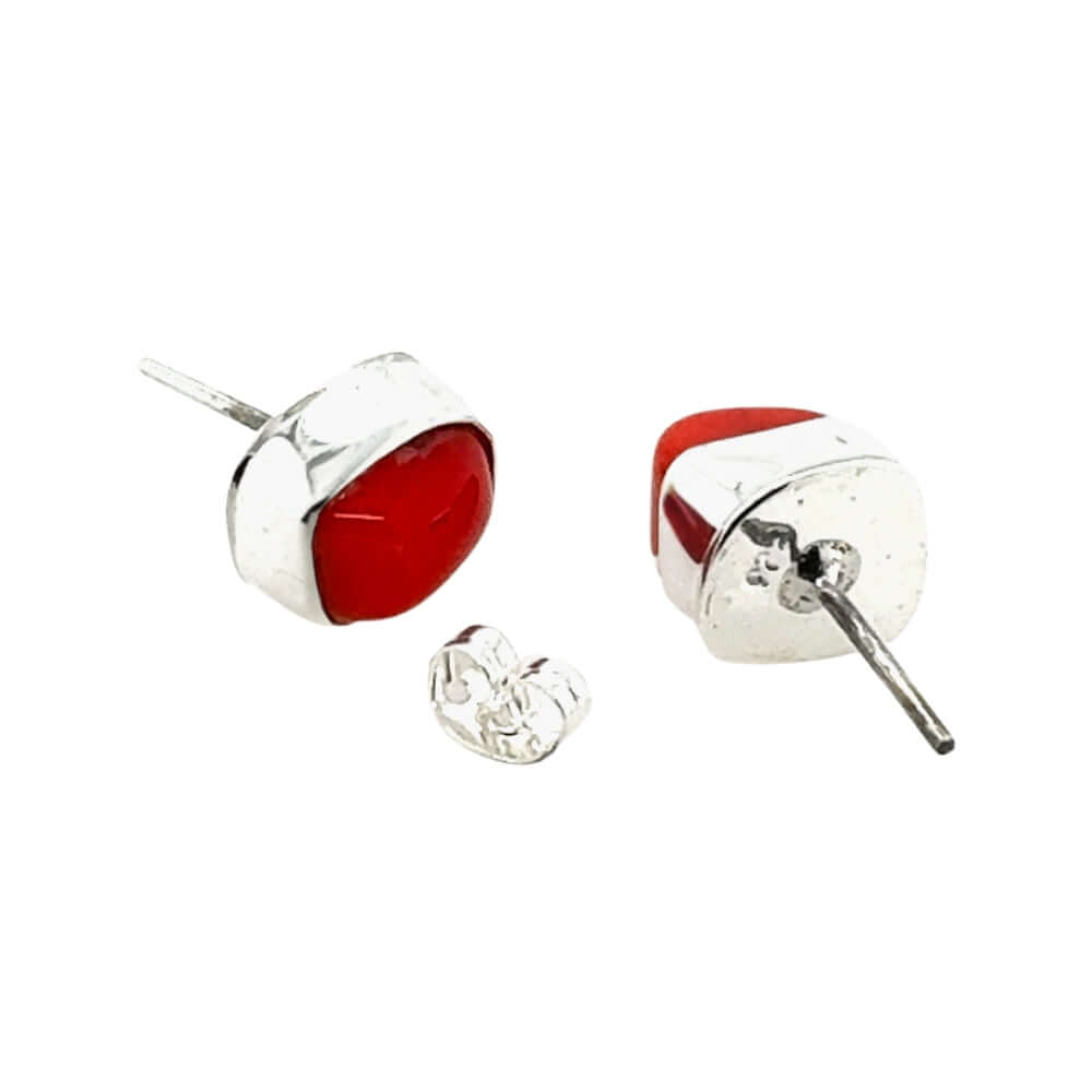 Pair of red coral and silver earrings on a white background