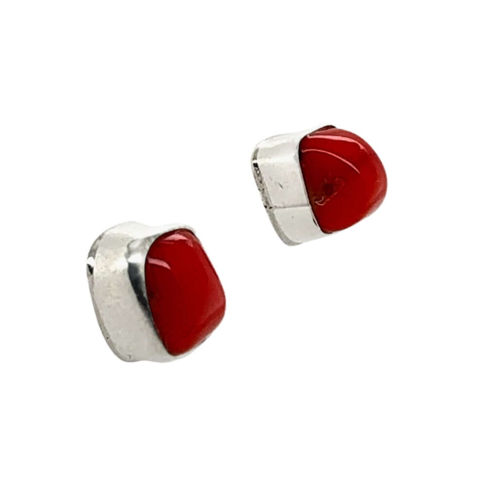 Pair of red coral earrings with silver accents on a white background