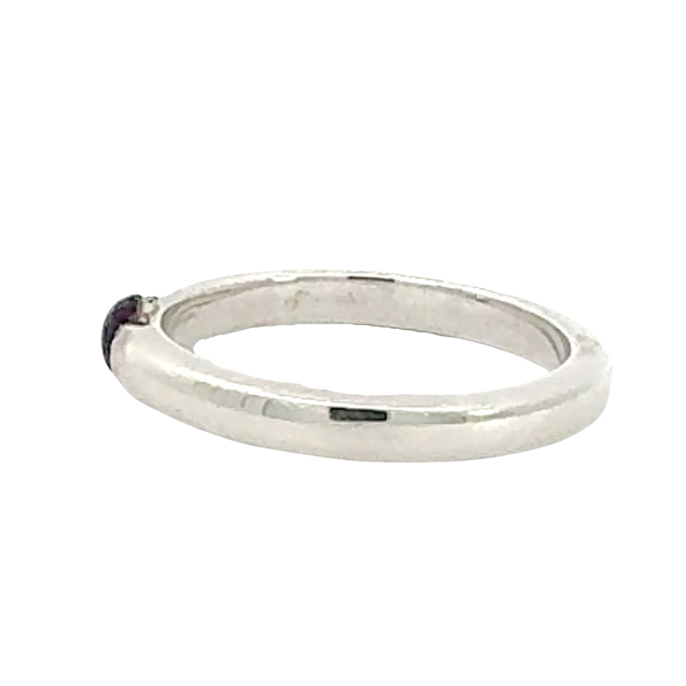 Silver ring with a small gemstone on a white background