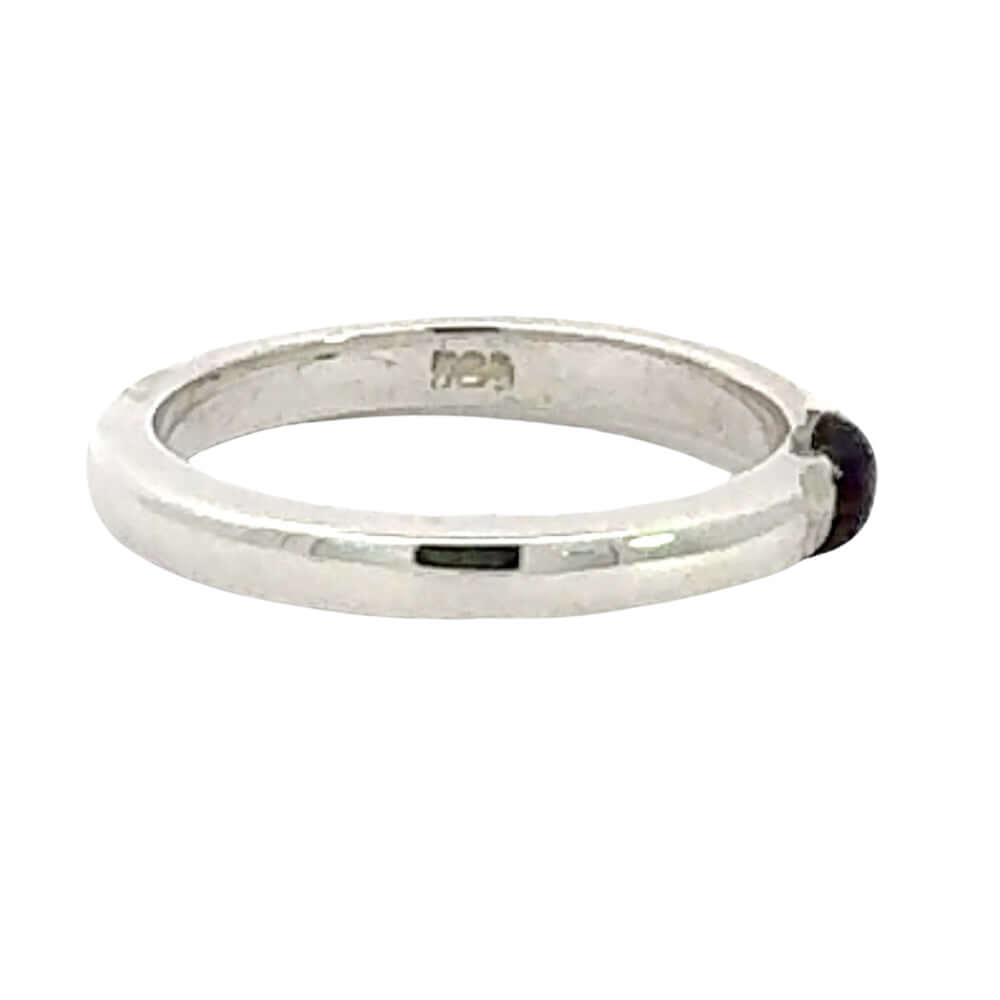 Silver ring with a small gemstone on a white background