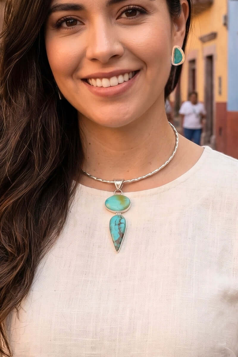 Woman in a Mexican town wearing a silver choker with a Sonoran turquoise pendant and turquoise silver earrings