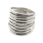 Silver ring with wavy design on a white background