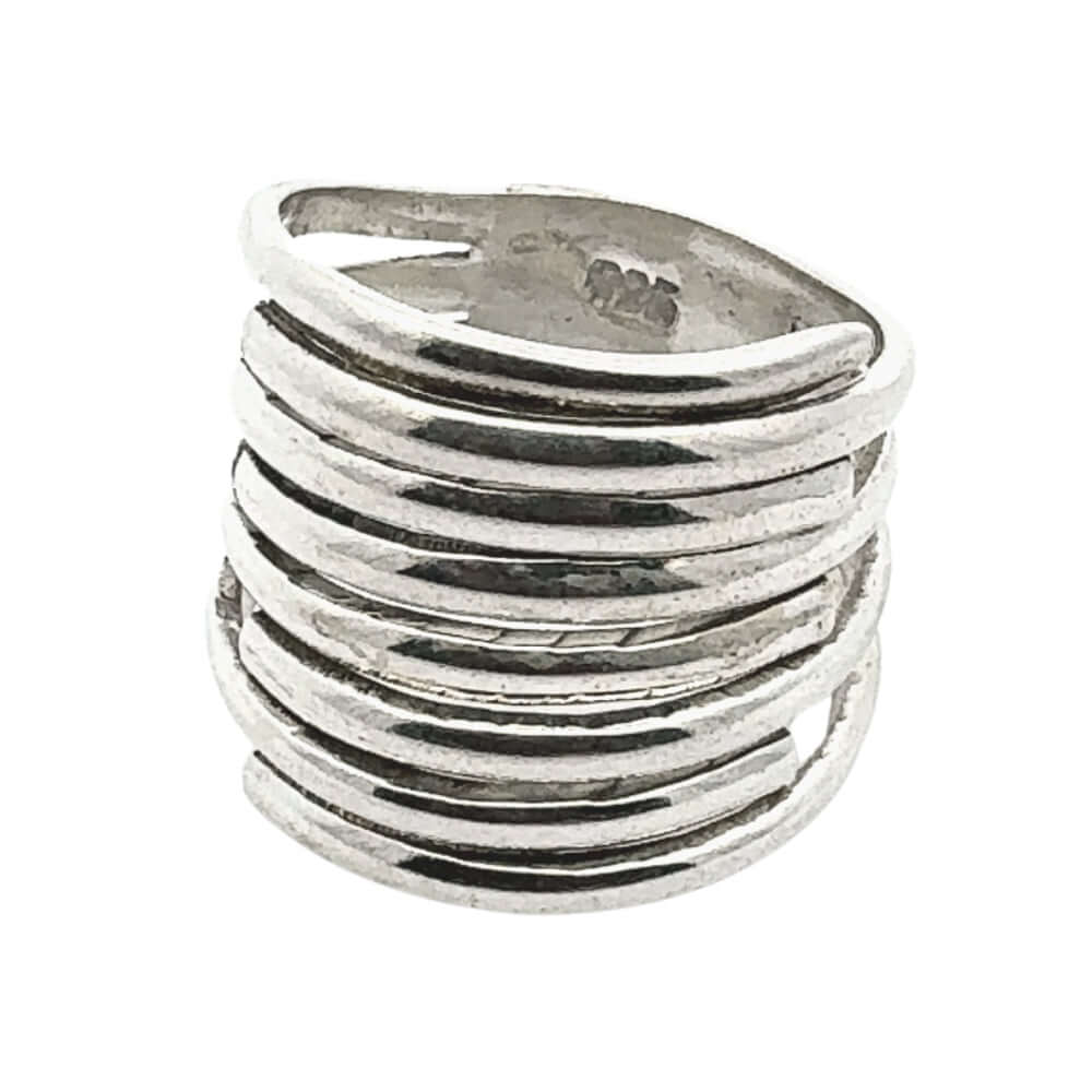 Silver ring with wavy design on a white background