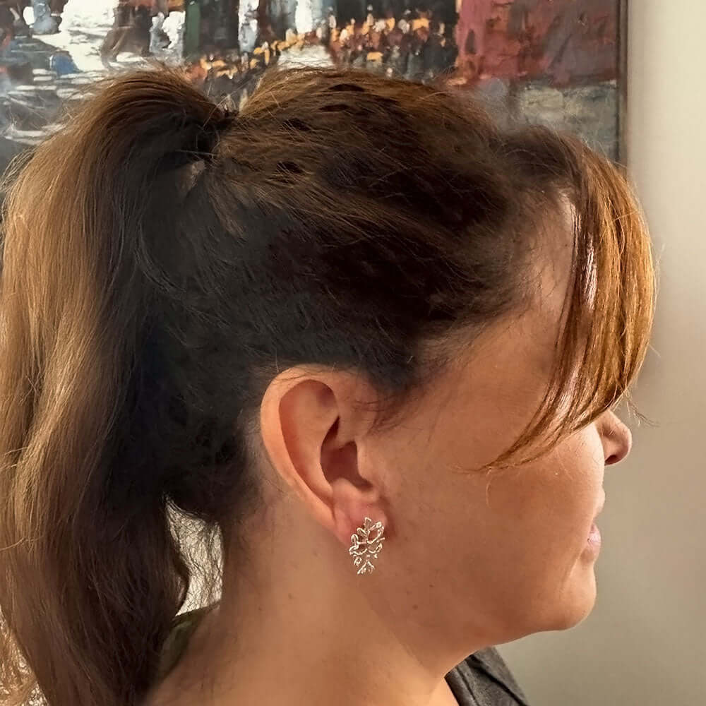 Sterling-Silver-Small-Leaves-Stud-Earrings-with-model-Nueve-Sterling