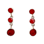 Pair of red coral earrings on a white background