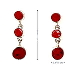 Red circular coral earrings with silver on a white background