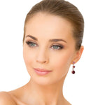 Close-up of a woman wearing silver coral earrings on a white background