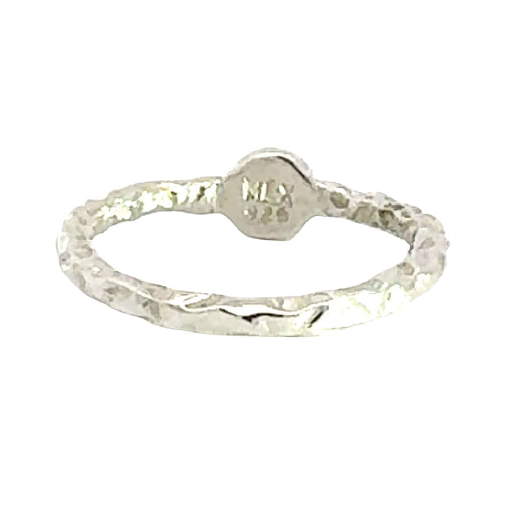 Back of a silver ring with textured design on a white background