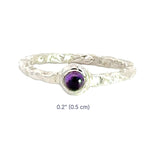Silver ring with a purple gemstone on a white background with dimensions