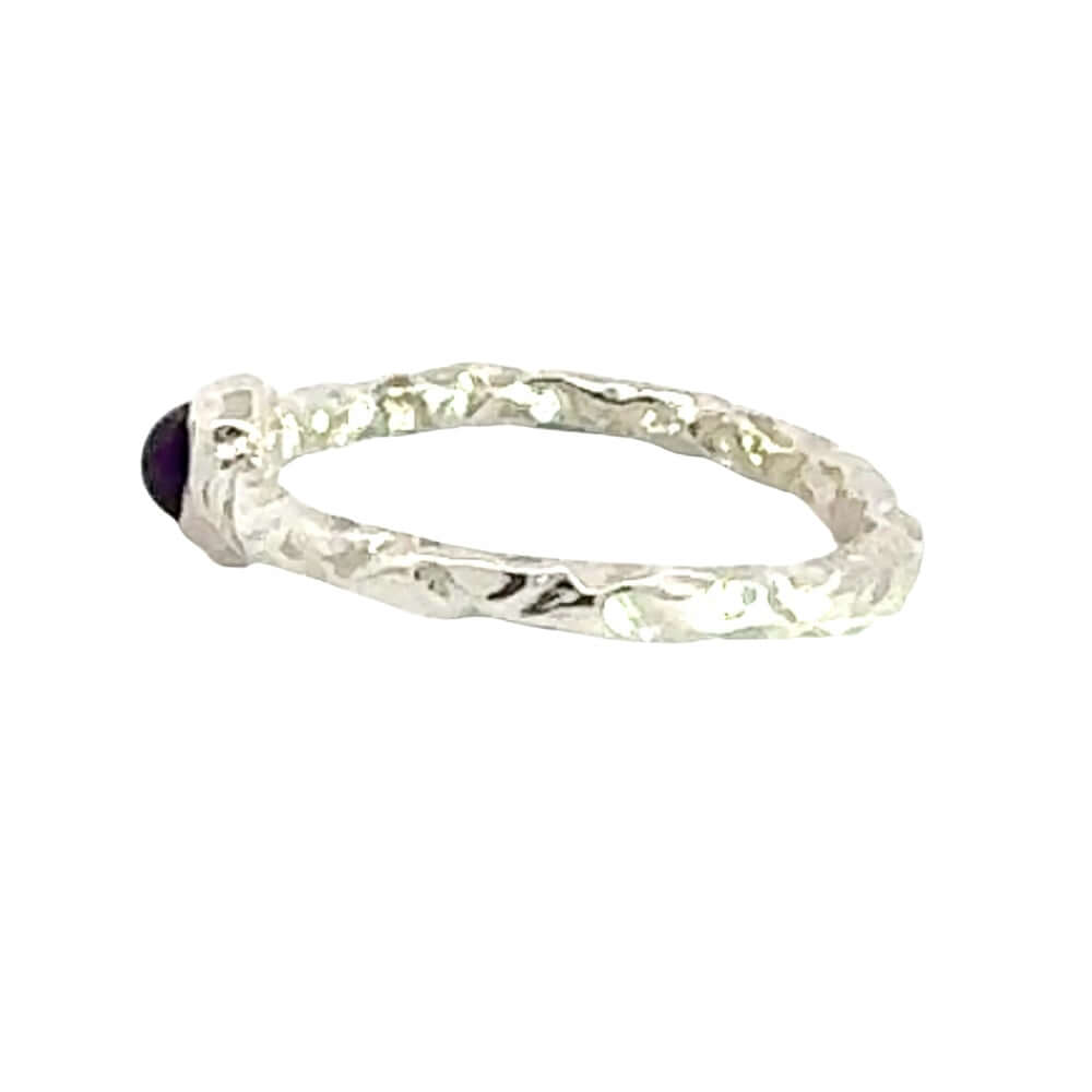 Silver ring with a gemstone on a white background