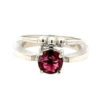 Silver ring with a pink gemstone on a white background