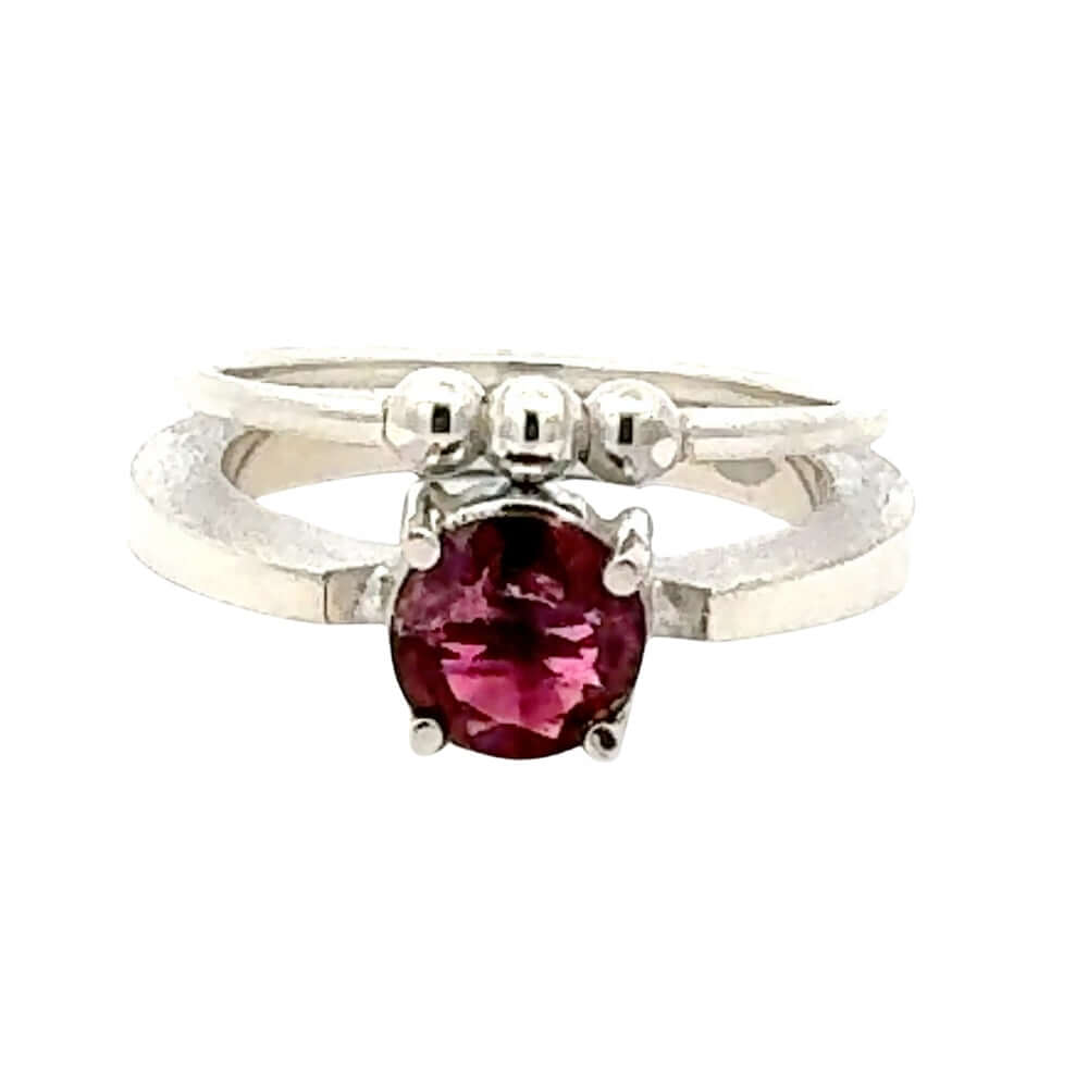 Silver ring with a pink gemstone on a white background
