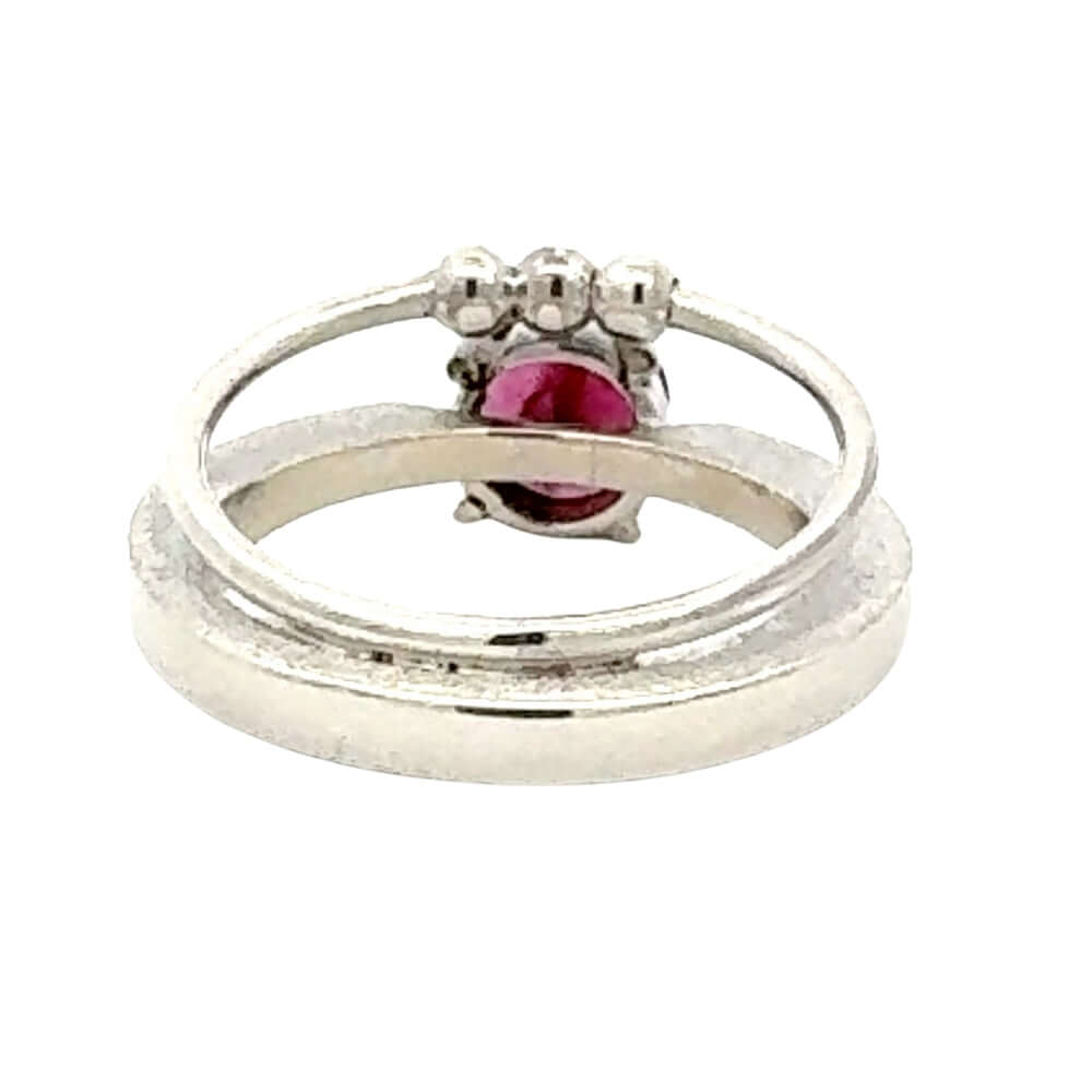 Silver ring with a pink gemstone on a white background