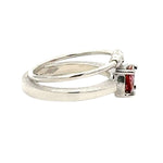 Silver ring with a pink gemstone on a white background