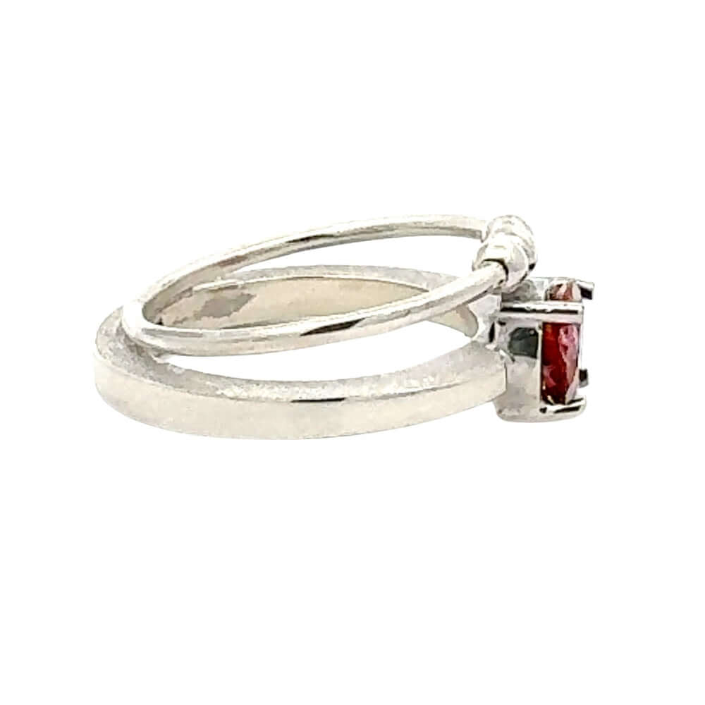 Silver ring with a pink gemstone on a white background