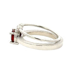 Silver ring with a pink gemstone on a white background