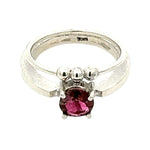 Silver ring with a pink gemstone on a white background