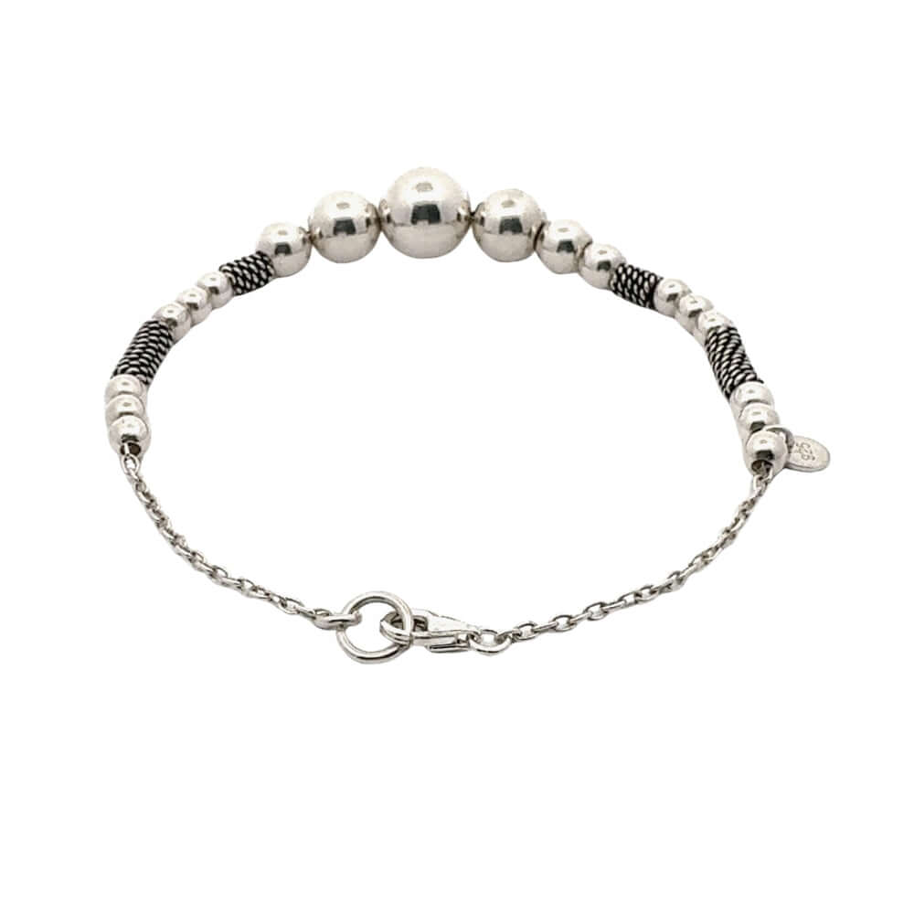 Silver beaded bracelet with chain on a white background