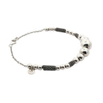 Bracelet with silver beads and black braided section on a white background