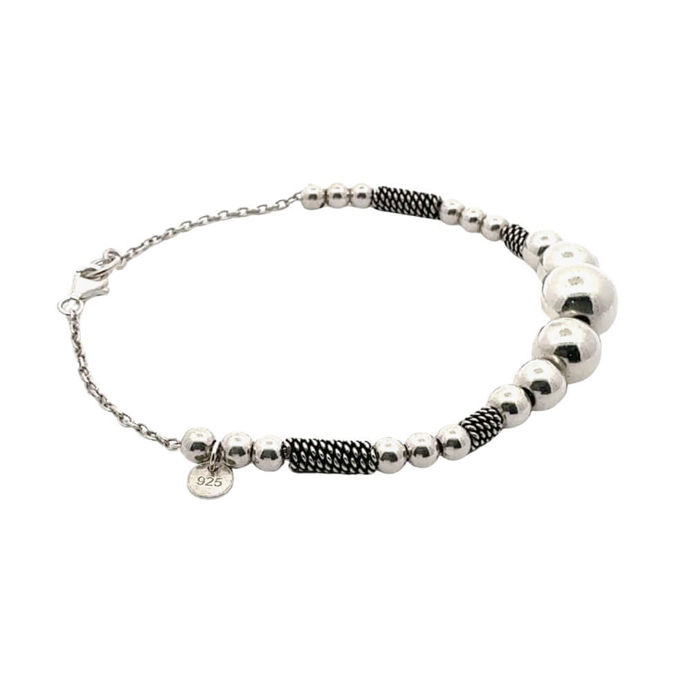 Bracelet with silver beads and black braided section on a white background