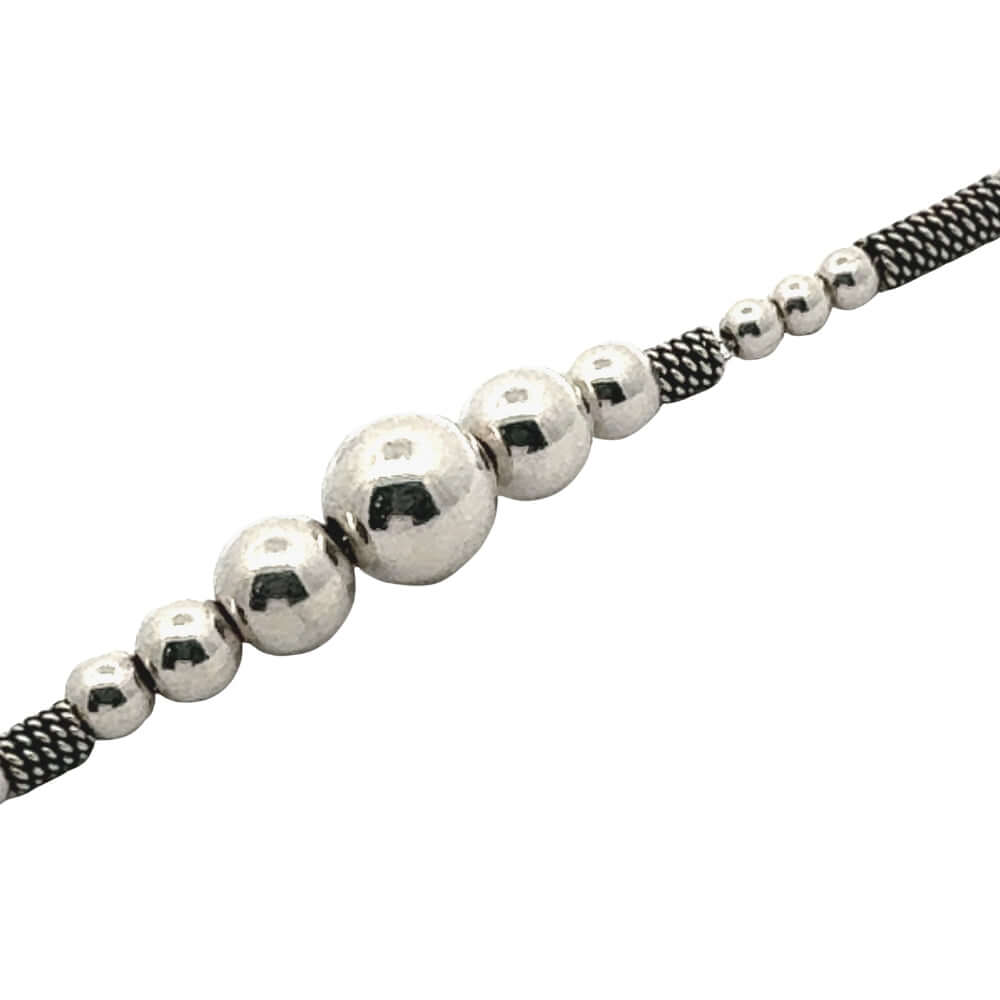 Silver beaded necklace on a white background