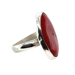 Silver ring with a red coral on a white background