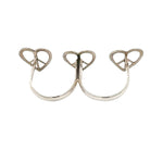 Silver ring with heart and peace symbol design on a white background