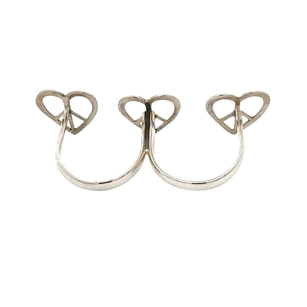 Silver ring with heart and peace symbol design on a white background
