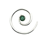Overhead view of a circular Taxco silver spiral pendant with a green tourmaline center