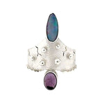 Front view of the 950 silver statement ring by Daniel Gutierrez featuring a fiery Australian opal and oval amethyst.