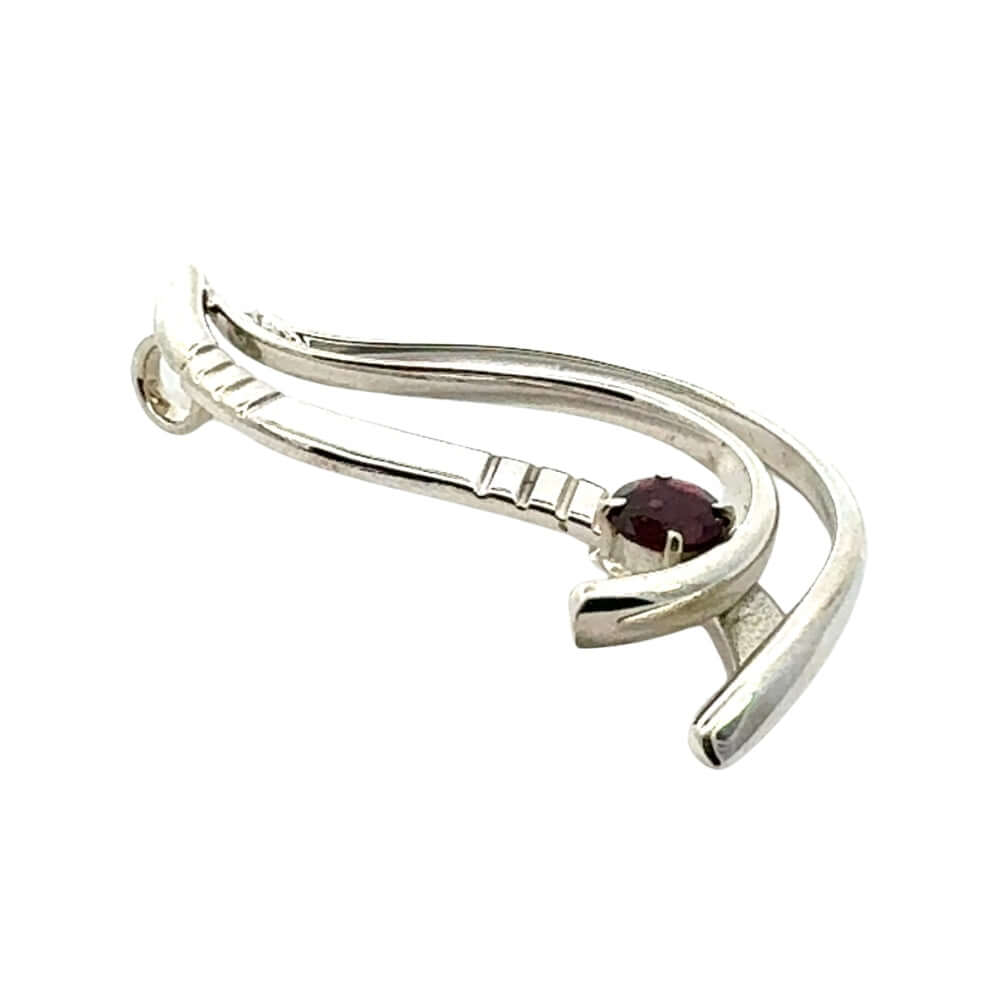 Side angle shot of a unique artisan silver pendant by Fernando Vergara