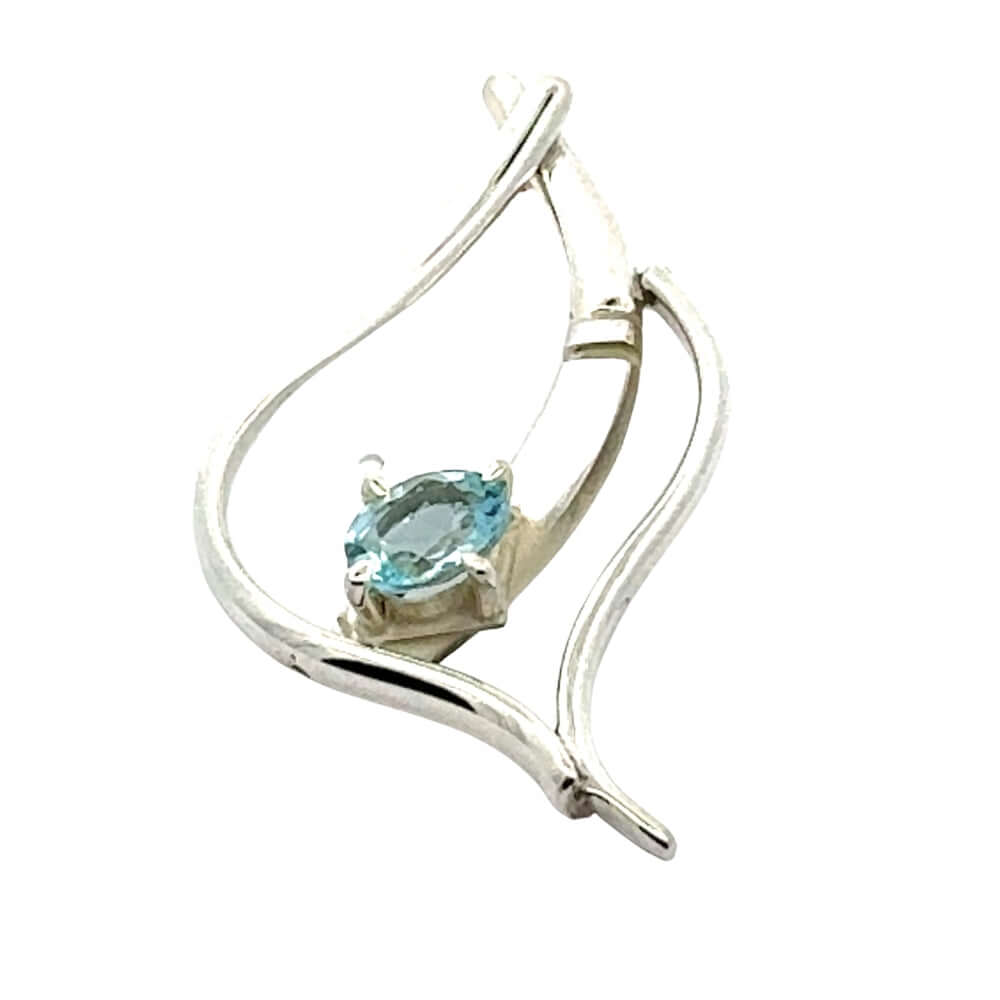 Detailed view of a handmade silver pendant featuring a blue topaz gemstone