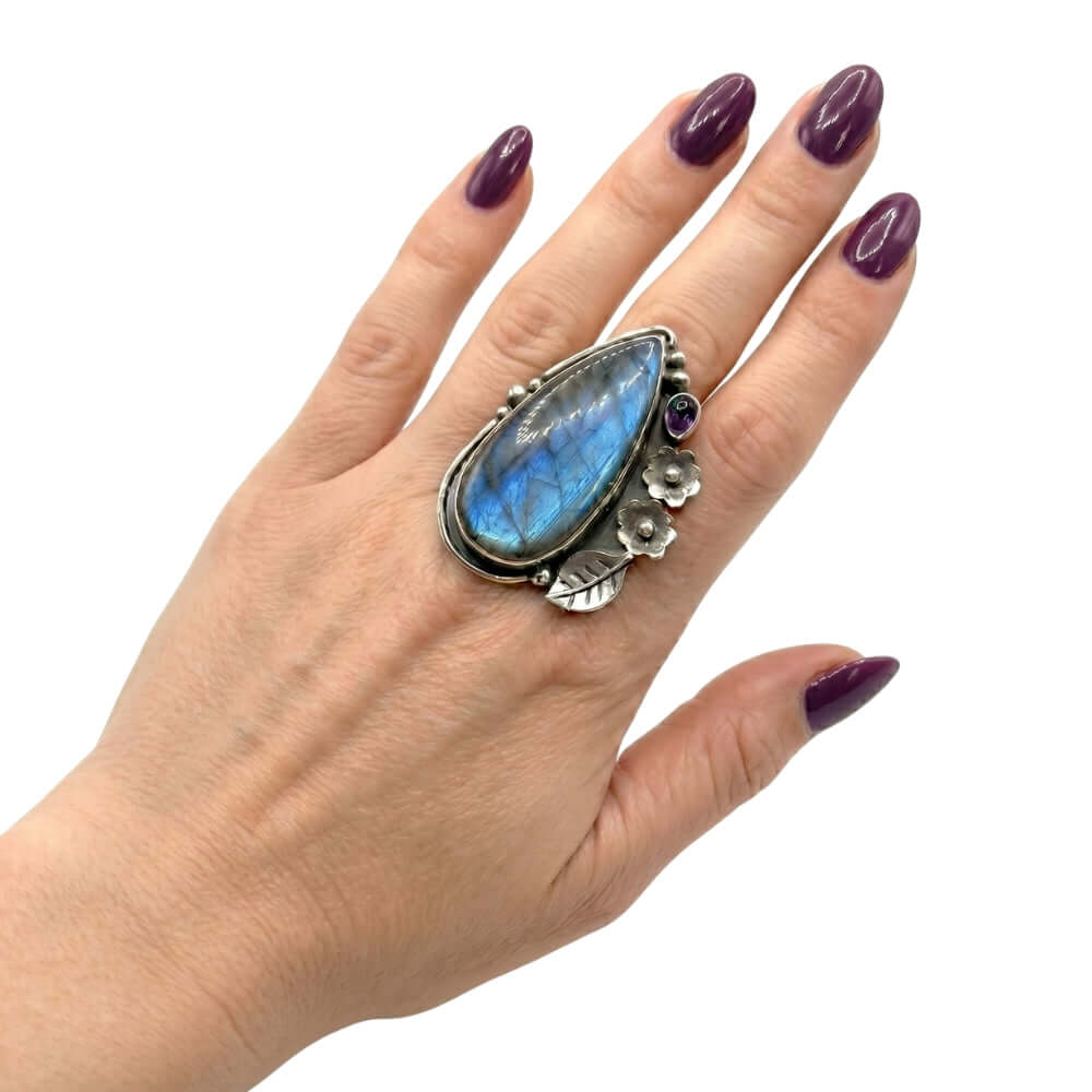High-purity silver chunky ring with gemstones shown on a hand to illustrate its elongated scale and adjustable size 7 fit.