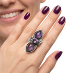 High-purity silver chunky ring showing the central faceted amethyst and outer cabochons on a hand to illustrate its scale and adjustable size 7 fit.