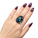 High-purity silver split-band chunky ring with gemstones shown on a hand to illustrate its scale and adjustable size 7 fit.