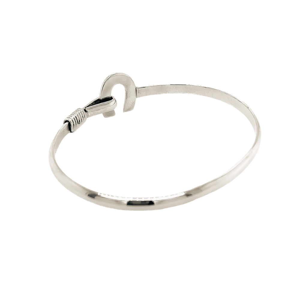 Rear lay of the solid silver bracelet demonstrating the clean, tapered band construction and flawless polish.