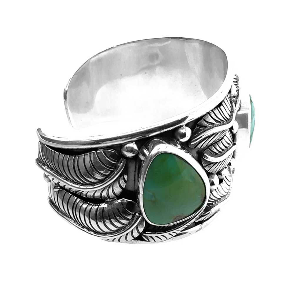 Side view of the wide silver cuff demonstrating the Sonoran turquoise and leaves details