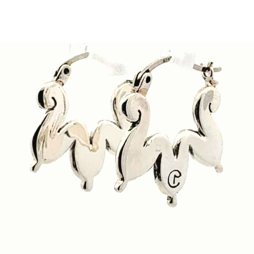 Perspective view of the curved silver cloud hoops showcasing the high-polish finish and artisan stamp