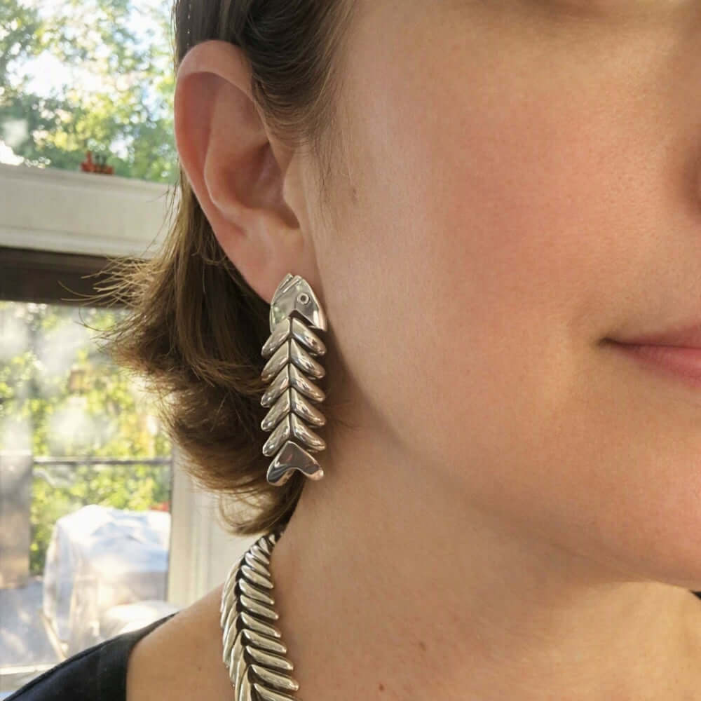 Model wearing a DMolina silver fishbone earring.
