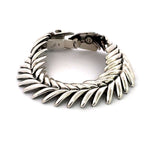 Side view of silver fishbone bracelet showing box clasp detail.